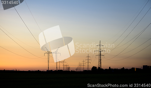 Image of Large transmission towers at sunset