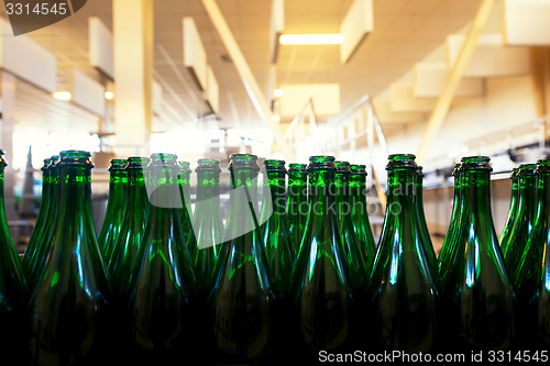 Image of Many bottles on conveyor belt