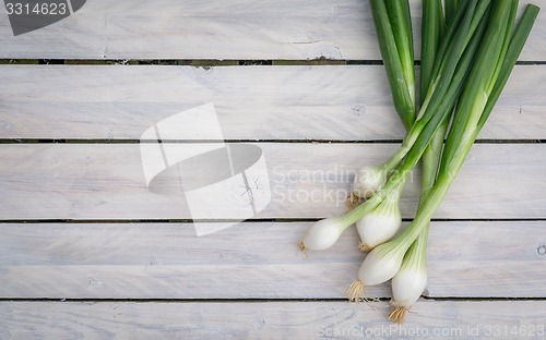 Image of Scallions on a wooden table