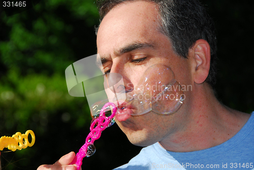 Image of Man blowing bubbles