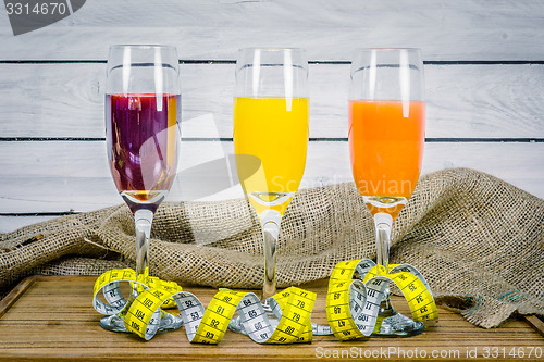 Image of Juice with measure tape wooden table