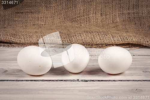 Image of Three eggs on a wooden table