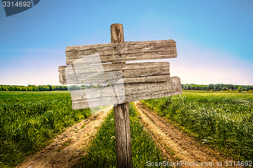 Image of Wooden sign on a country road