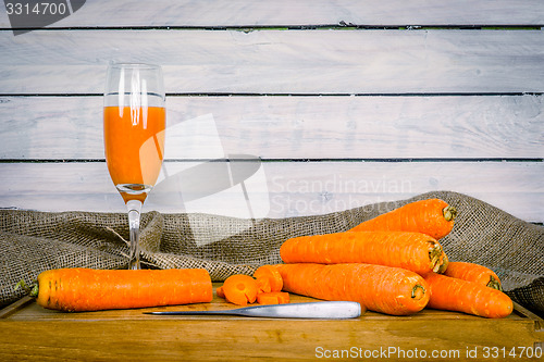 Image of Carrot juice on a wooden board