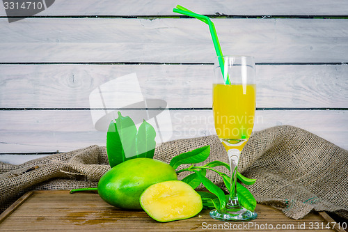 Image of Mango juice on a wooden table