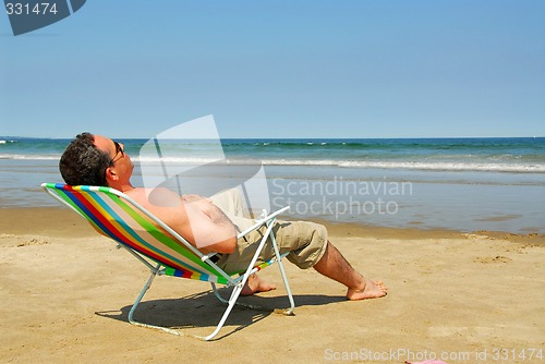 Image of Man relaxing on beach