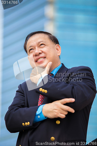 Image of Senior Asian businessman in suit smiling portrait