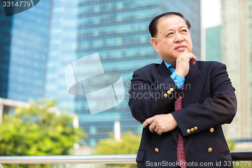 Image of Senior Asian businessman in suit smiling portrait