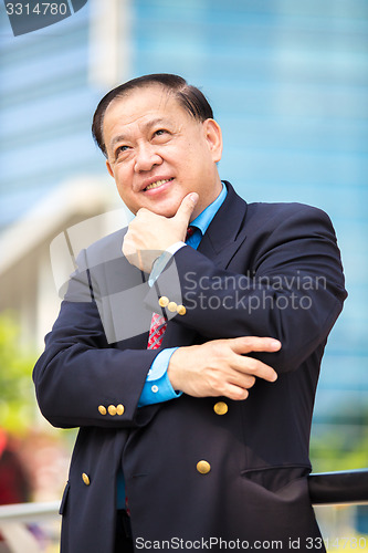 Image of Senior Asian businessman in suit smiling portrait