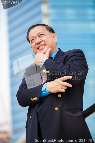 Image of Senior Asian businessman in suit smiling portrait