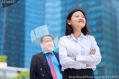 Image of Young Asian female executive and senior businessman in suit portrait
