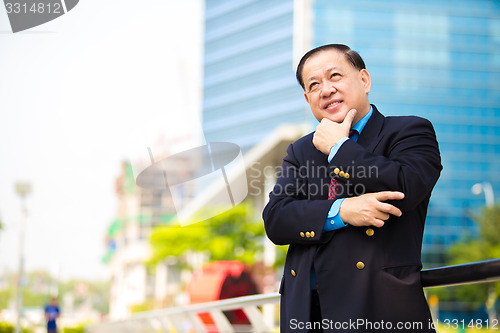 Image of Senior Asian businessman in suit smiling portrait