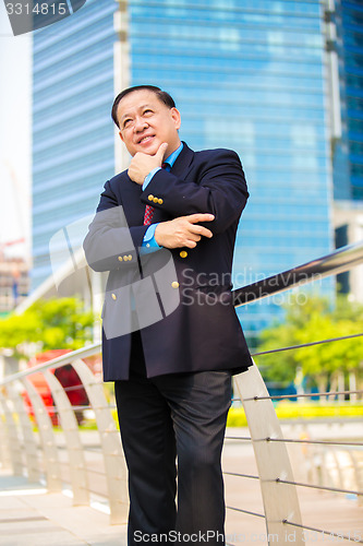 Image of Senior Asian businessman in suit smiling portrait