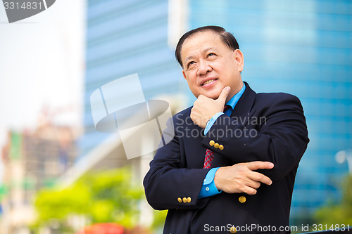 Image of Senior Asian businessman in suit smiling portrait