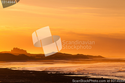 Image of View of the  Bamburgh castle in a spectacular sunset 