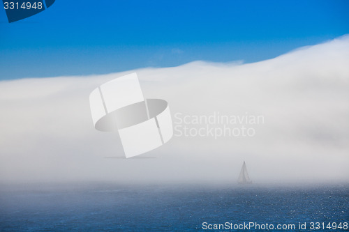 Image of Lonely sailboat in the morning mist