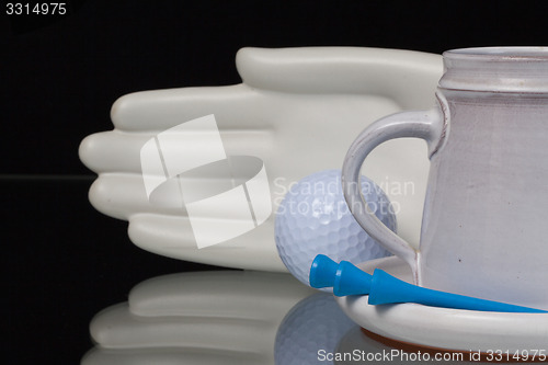 Image of Ceramics hand and golf equipments 