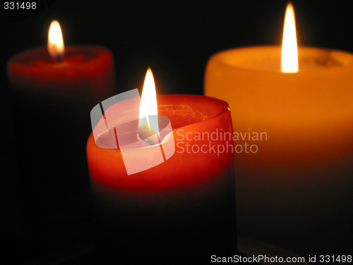 Image of Three burning candles