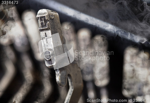 Image of E hammer - old manual typewriter - mystery smoke