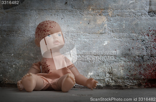 Image of Concept of child abuse - Bloody doll