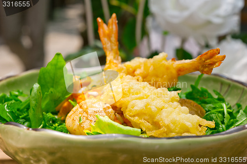 Image of fresh Japanese tempura shrimps with salad