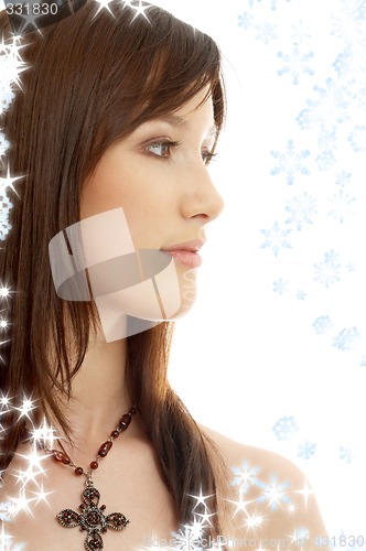 Image of lovely brunette with cross and snowflakes