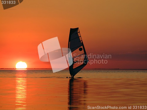 Image of Silhouette of a windsurfer on waves of a gulf on a sunset 2