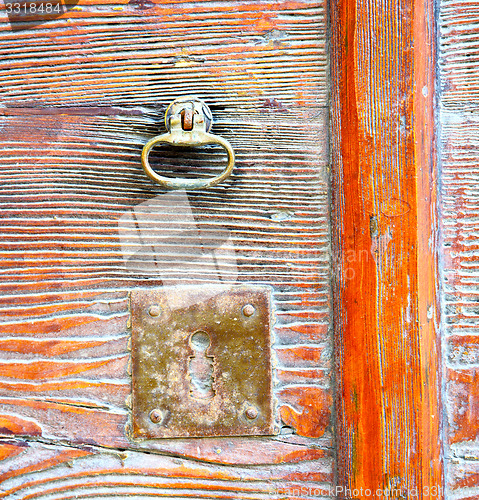 Image of  varese abstract  rusty brass brown knocker in a    