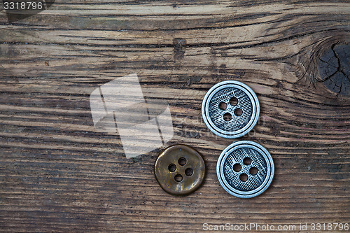 Image of set of vintage buttons on wooden boards aged antique table. inst