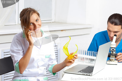Image of Doctor talking on a cell phone in lab