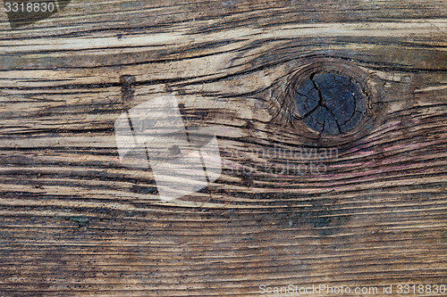 Image of aged wooden boards with a knot