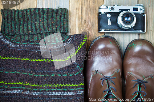 Image of Vintage sweater, shoes, antique rangefinder camera