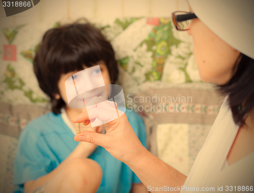 Image of doctor with pill and smiling boy