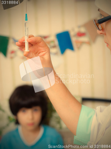 Image of Doctor pediatrician with a syringe