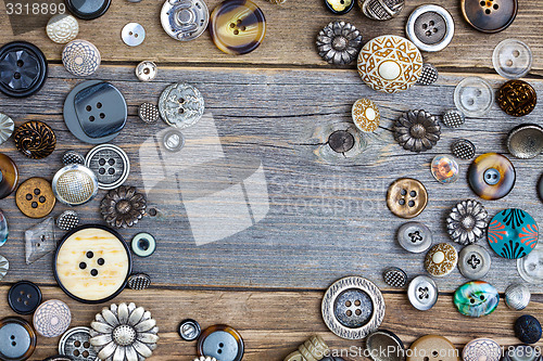 Image of set of vintage buttons on aged wooden boards