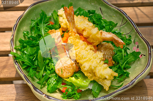 Image of fresh Japanese tempura shrimps with salad