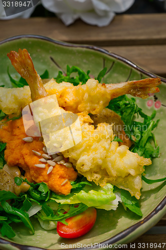 Image of fresh Japanese tempura shrimps with salad