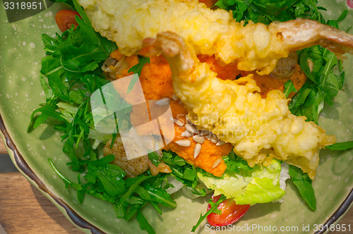 Image of fresh Japanese tempura shrimps with salad