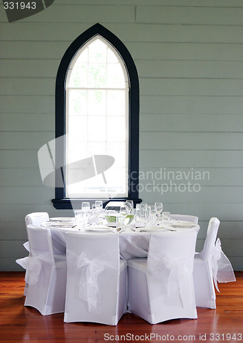 Image of Tables decorated at a wedding reception.