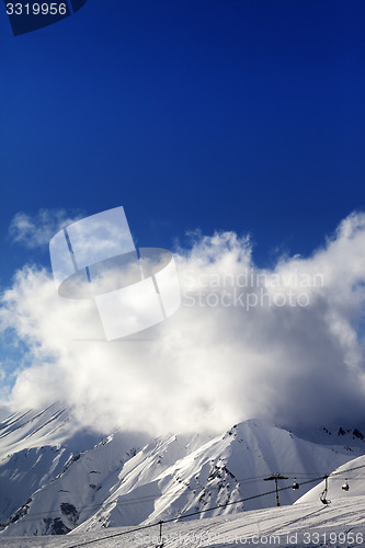 Image of Ski slope with ropeway at sun evening