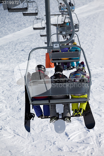 Image of Snowboarders on chair-lift
