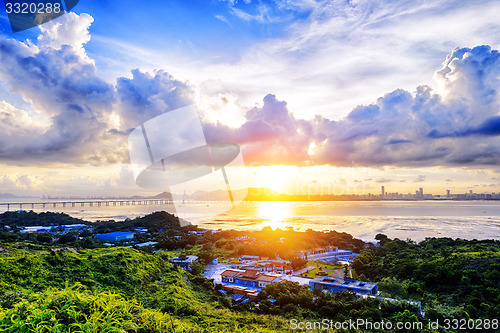 Image of Village with beautiful sunset over hong kong  coastline. 