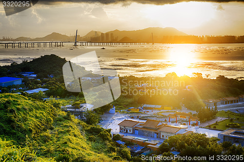 Image of Village with beautiful sunset over hong kong  coastline. 