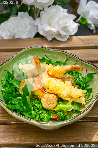 Image of fresh Japanese tempura shrimps with salad