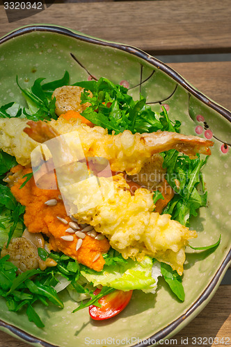 Image of fresh Japanese tempura shrimps with salad