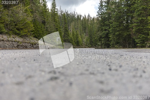 Image of Winding road bends in  rural, desolate, mountain landscape.  Europe.