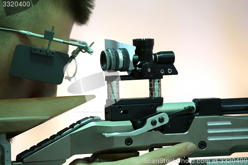 Image of young man aiming a pneumatic air rifle