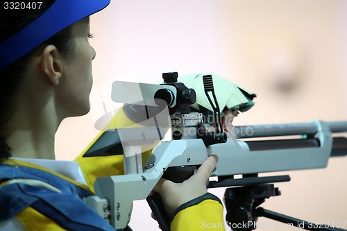 Image of woman aiming a pneumatic air rifle