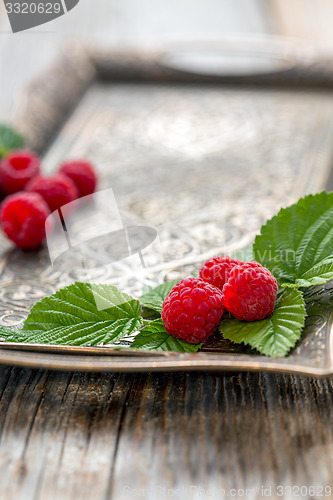 Image of Leaves and ripe raspberries.
