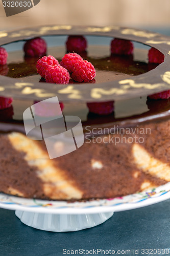 Image of Cake with chocolate icing and raspberries